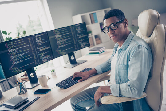 Photo of young man self employed introvert programmer working on freelance github website for coders in internet at office background