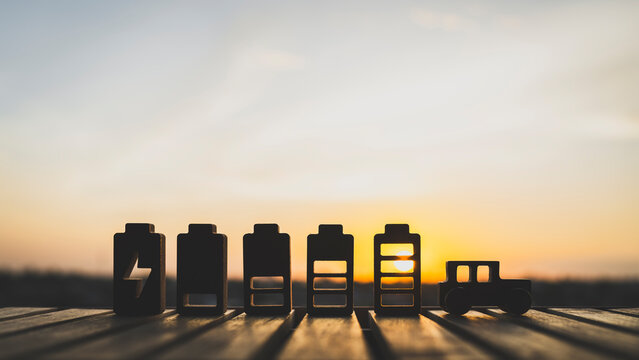 Wooden car and lithium battery model, Technology battery high power electric energy with a connected charging cable. Battery to electric cars and mobile devices with clean electric.	