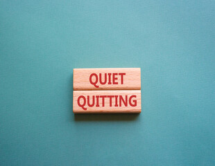 Quiet quitting symbol. Concept word Quiet quitting on wooden blocks. Beautiful grey green background. Business and Quiet quitting concept. Copy space.