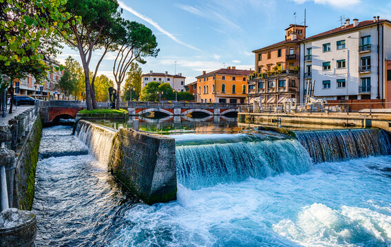 Fototapeta Evening view of the San Martino bridge. Italian city of Treviso in the province of Veneto. View of the river Sile and the architecture of the city of Treviso Italy. 