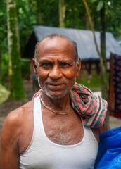 Portrait of a south asian elderly rural man having a towel on his neck 