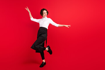 Full size photo of charming nice young funky woman dance smile hostess isolated on red color background