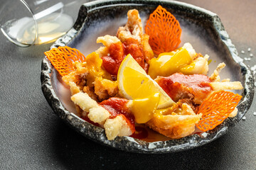 Italian dish fried seafood: shrimp, squid, octopus and a slice of lemon. Italian fast food. Fish...