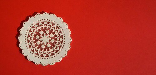 white openwork stand for hot, red background for decoration. minimalistic abstract composition