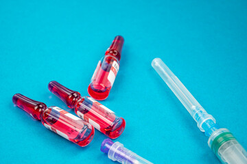 Ampoules with syringes for medical injections. Drugs use for treatment the disease. Cylinder and hypodermic syringe