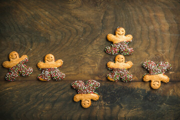 Sweet cookie characters with chocolate on a dark wooden background