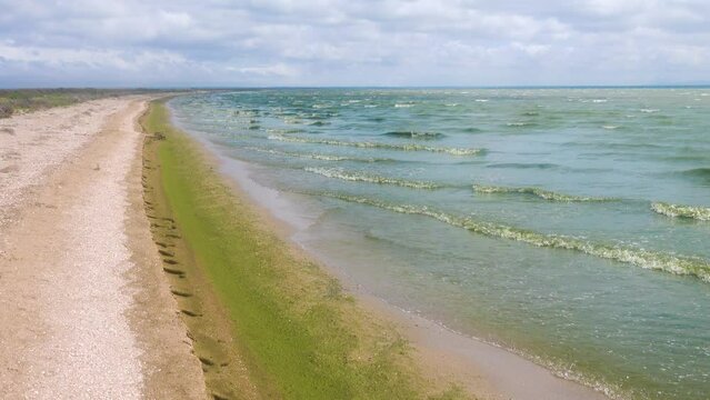 Lagrangian wave. The shore of the hypersalted shallow lake Sivash in storm weather. The Sea of Azov