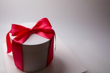 creaked gift on top of a post with red ribbon tied around the front