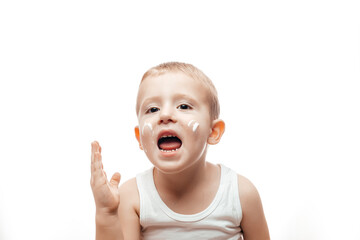 applying moisturizing cream on baby face on white background. Care about children clean and soft...