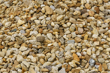The texture of small stones lying along the sea coast.