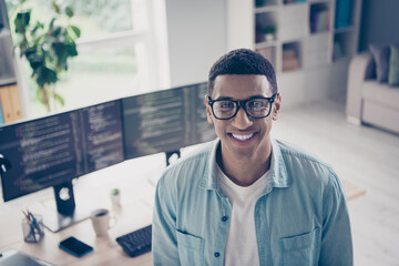 Portrait photo of young funny man successful javascript coder toothy smiling in his home office outsource worker wear eyeglasses indoors
