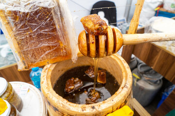 Natural sweet healthy honey in wooden barrels for sale. Healthy eating. Healthy lifestyle.