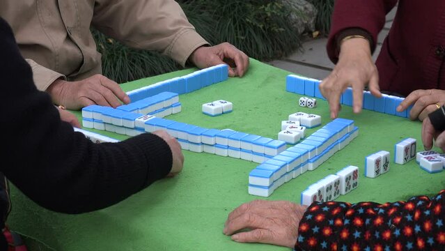 Chinese people play a traditional Mahjong game in a park in Hangzhou
