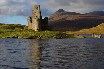 The Ruin of 16th Century Ardvreck Castle sat on a Rocky Promontory in Loch Assynt, Sutherland, Scotland with Glas Bheinn (776m) behind.