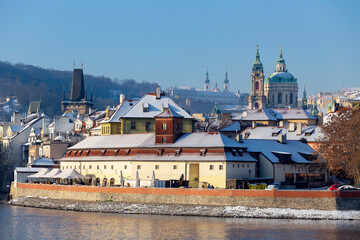 Snowy Prague Lesser Town with Prague Castle above River Vltava in the sunny Day , Czech republic
