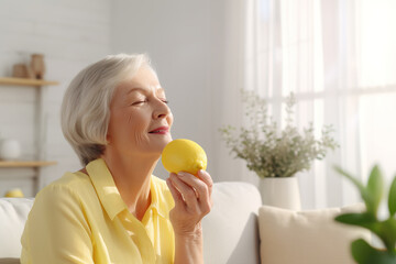 Attractive mature woman enjoying lemon aroma at home. Aromatherapy, Return of smell after Covid