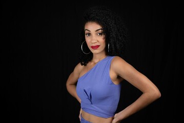 Naklejka premium Portrait of serious, beautiful young woman wearing blue outfit. 