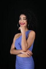 Fototapeta premium Young beautiful smiling woman with hand on chin, wearing blue ou