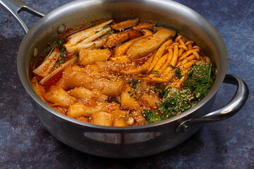 Tteokbokki-  Korean rice cakes and mushrooms, bok choy hot pot stew,