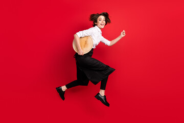 Full body profile side photo of brunette bob haired lady jump up runner hold tray isolated on red...