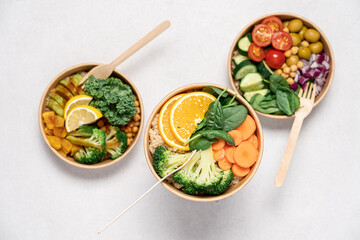 Takeaway food salads Buddha bowl in round cardboard containers. Mediterranean, with broccoli and...