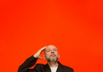 Business man, wearing black suit jacket, smart and thoughtful.