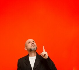 Business man, mature, elegant, pointing his finger up. 