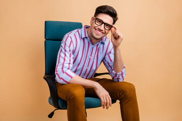 Photo of nice cheerful man wear trendy clothes sitting chair holding eyeglasses interviewing...