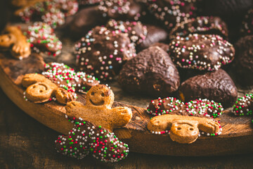 Sweet christmas cookies, gingerbread, on a dark wooden table