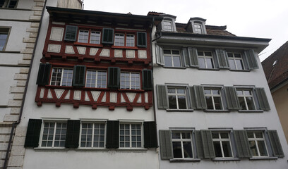 Beautiful facades of historic houses at the old town of Swiss City of Schaffhausen on a foggy winter day.