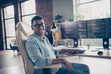 Portrait of young smiling guy sitting armchair smart senior devops professional programmer control cyber security at work place in office - obrazy, fototapety, plakaty
