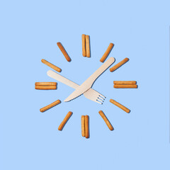 Clock with hands for a fork and knife, cookies in the form of numbers.