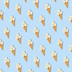 Seamless pattern of stylish mockup with banana slices in an ice cream waffle cone on a pastel blue background. Creative healthy food concept.