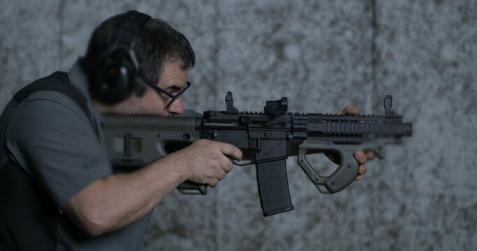 Firing a CQR rifle in super slow-motion 800 fps at shooting range. Shooter aiming and fires gun