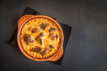 Tave kosi is a national Albanian dish of baked lamb and rice with yoghurt close-up in a pan on the table. horizontal top view from above. Turkish name; Elbasan tava - obrazy, fototapety, plakaty