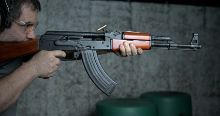 Firing AK-47 Rifle, 800fps High-Speed Slow-Motion Kalashnikov Shooting, close-up of classical weapon