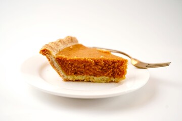 Sliced pumpkin pie isolated on white background, selective focus