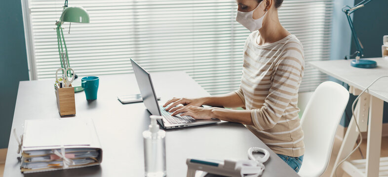 Business Woman Working In The Office And Wearing A Face Mask