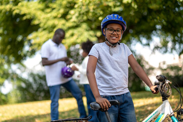 Kids spending time with dad and learning to ride a bike