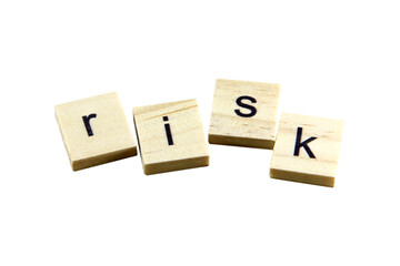 Short word english letter with text "risk" on a small wooden cubes block with bright background.Copy space concept and selection focus.