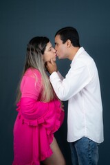 Happy pregnant Caucasian woman posing with her loving husband for a maternity shoot