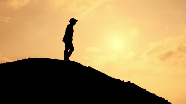 Silhouette of a happy man jogging in the mountains in the evening, exercise concept keeps you healthy.