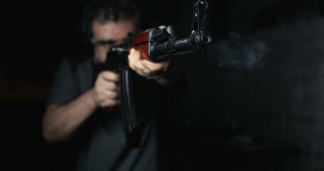 Man aiming with Kalashnikov Weapon firing in super slow-motion at high-speed 800 fps, AK-47 Rifle front view