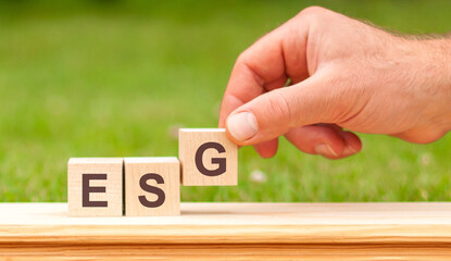 ESG concept of governance and social environment. hand holding wooden cube with letter G icon