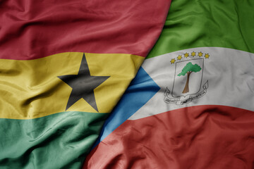 Fototapeta premium big waving national colorful flag of ghana and national flag of equatorial guinea .