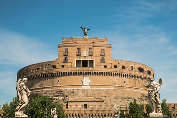 Castel Sant'Angelo, also called Mausoleum of Hadrian, against a blue sky, and statues of Ponte Sant'Angelo, Rome, Italy
