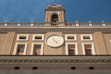 Front facade with clock and tower of the Roman College, a former jesuit school, Rome, Italy