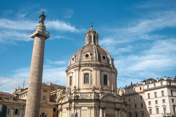 Fototapeta na wymiar Trajan's column and the church 'Santissimo Nome di Maria al Foro Traiano' in Rome, Italy