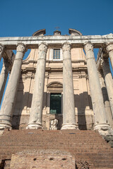 Columns of the Temple of Antoninus and Faustina and behind it the church of San Lorenzo in Miranda at the Roman Forum, Rome, Italy