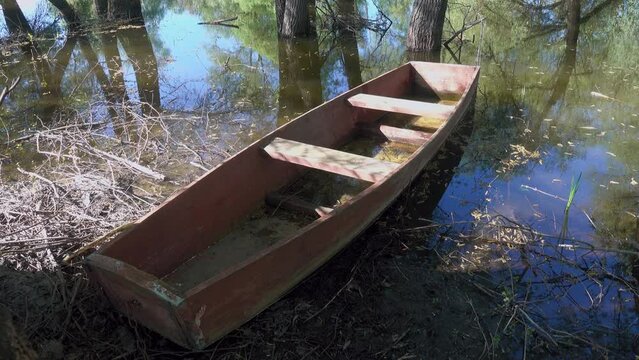 Old style boat, primitive box-shaped wooden boat for sailing in small inland reservoirs on the banks of the dead arm of river and floodplain forest. Don River. Russia